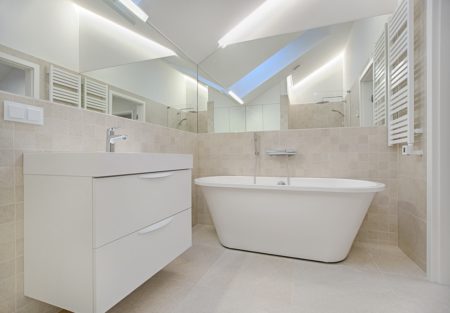 a bathroom with a tub and sinks