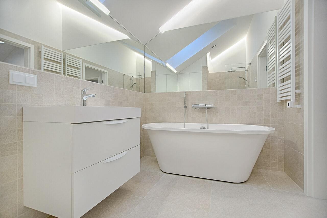 a bathroom with a tub and sinks