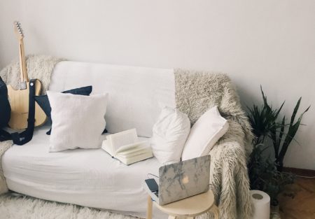 a bed with a white sheet and pillows
