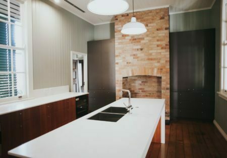 a kitchen with a brick wall