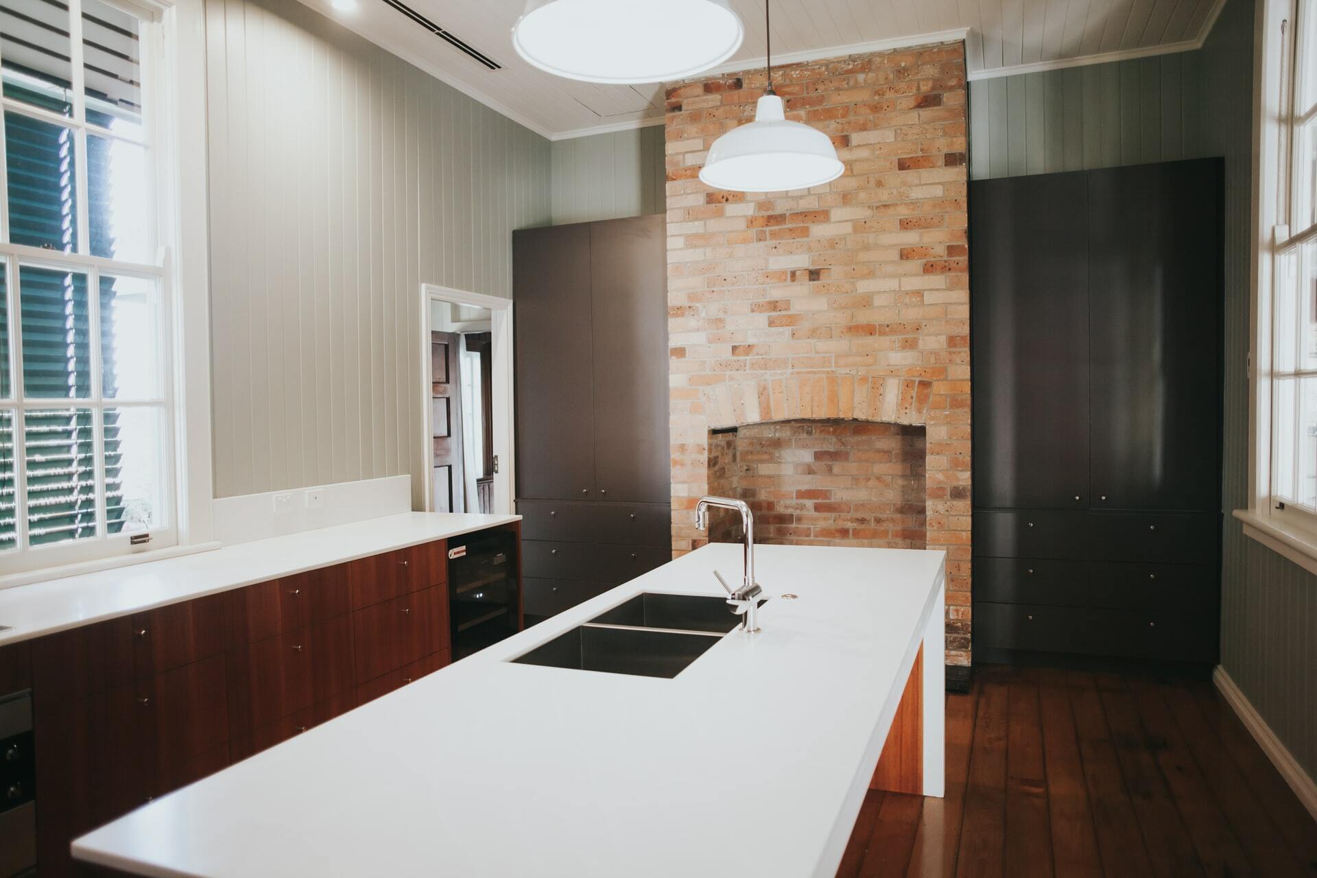 a kitchen with a brick wall