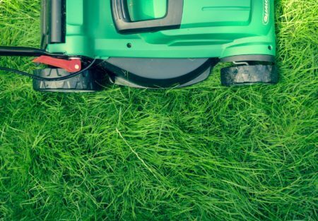 a green lawnmower on grass