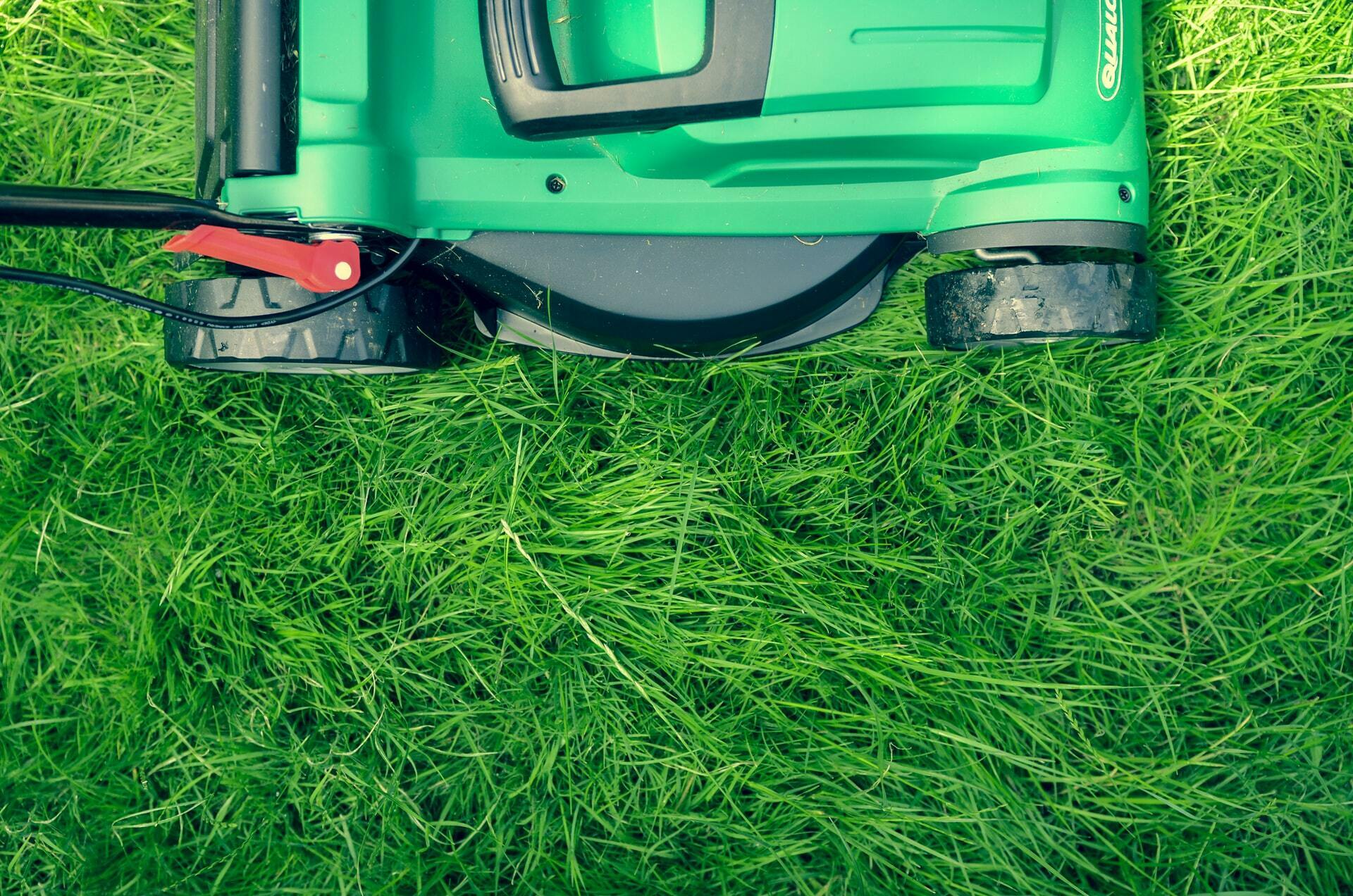 a green lawnmower on grass