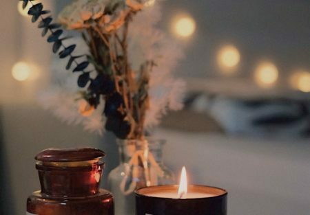 a candle and a vase with flowers