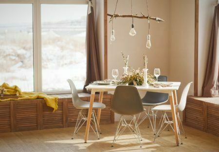 a dining table and chairs in a room with a window