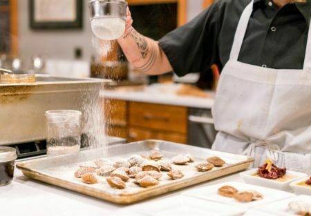 a chef preparing cookies in a kitchen