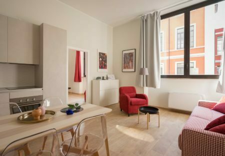 a living room with a table and chairs