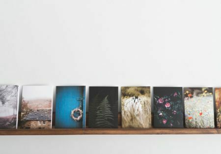 a group of paintings on a shelf