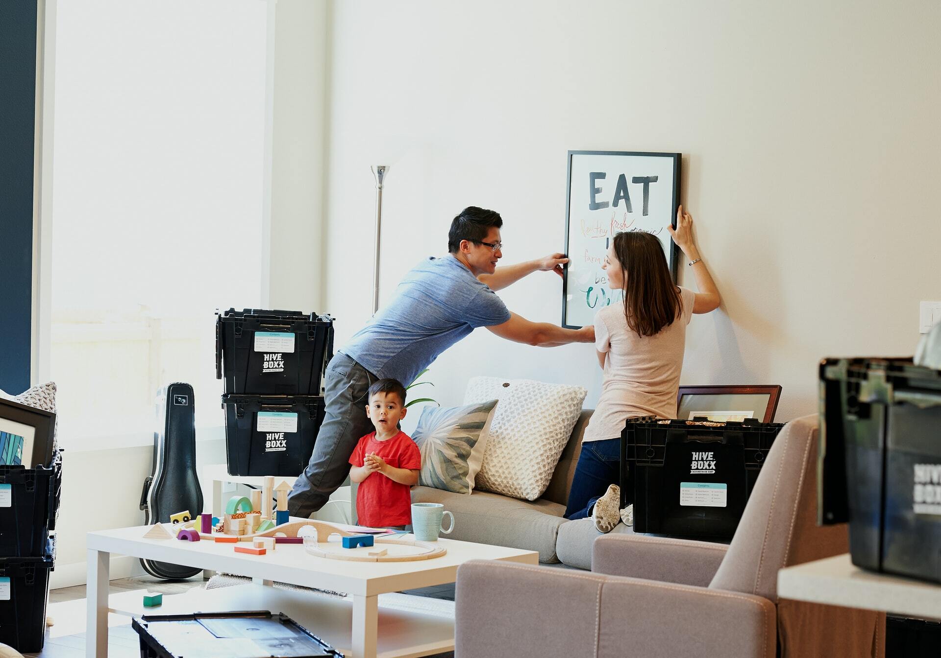 a man and woman jumping in the air in a living room