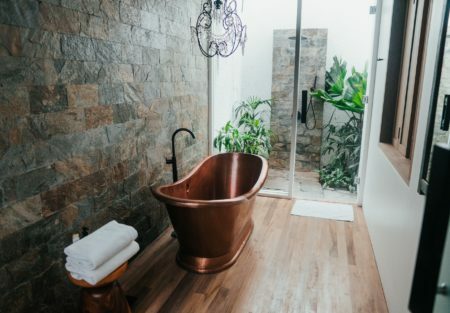 a bathroom with a stone wall
