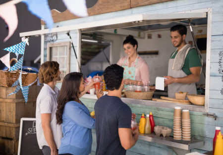 a group of people standing around a counter