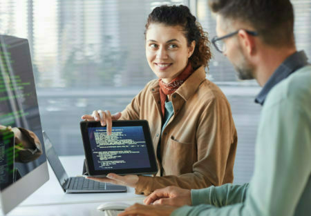 a man and a woman looking at a laptop