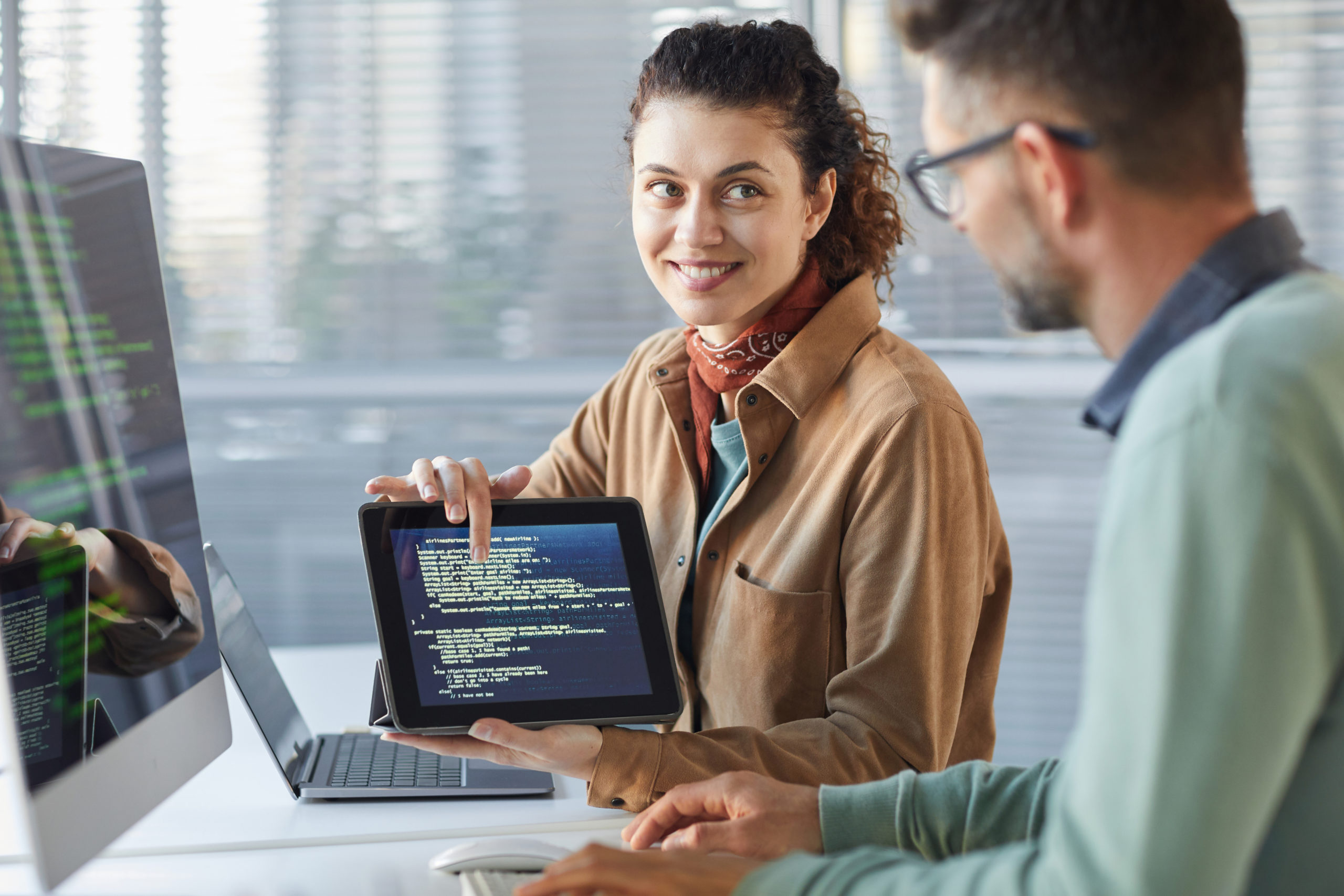 a man and a woman looking at a laptop