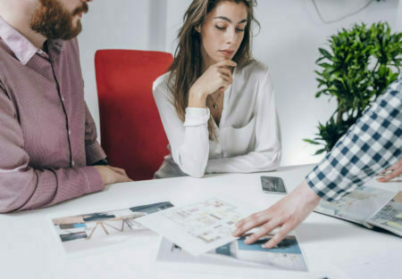 a woman sitting at a table with a man sitting at her