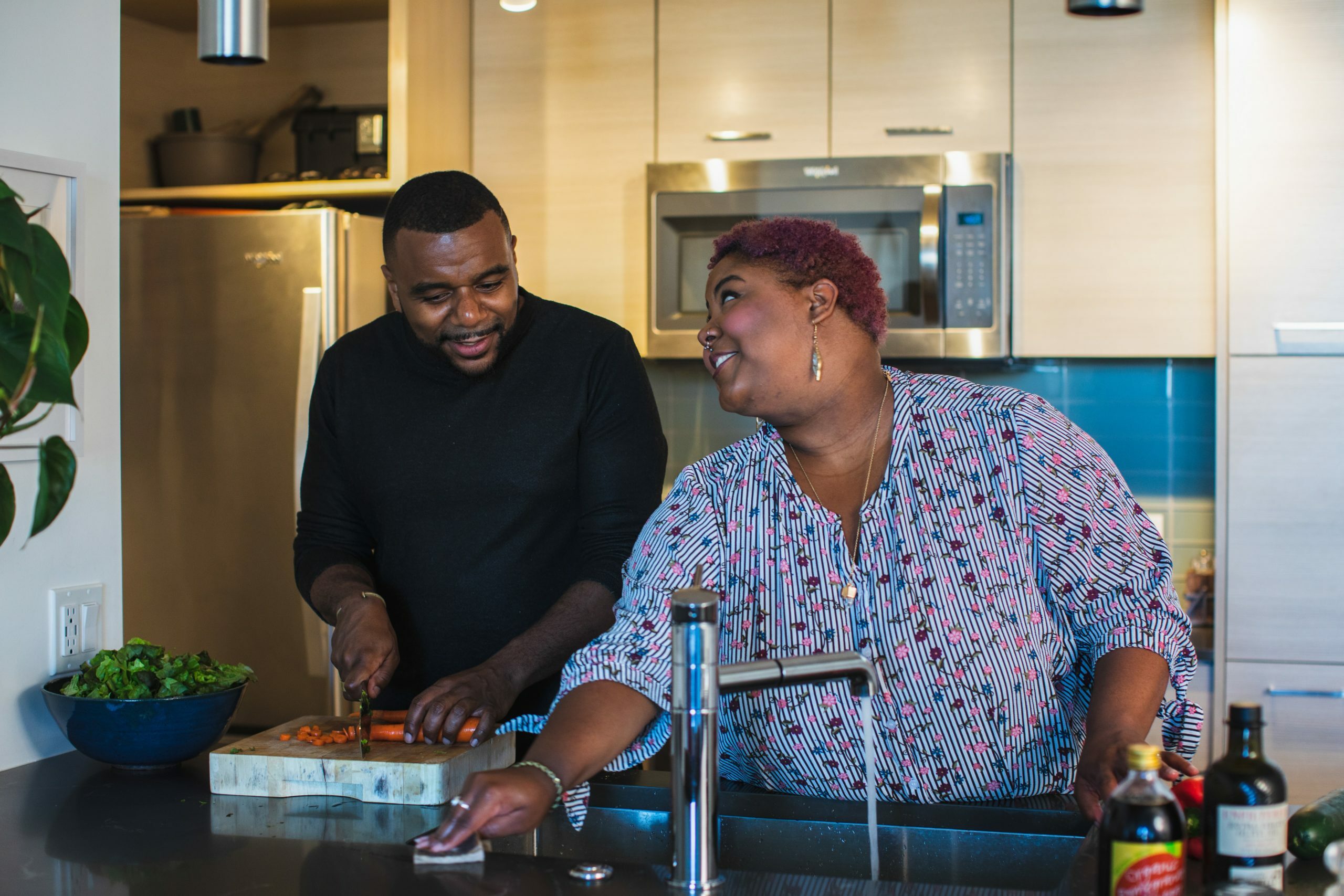 a man and a woman cooking in a kitchen